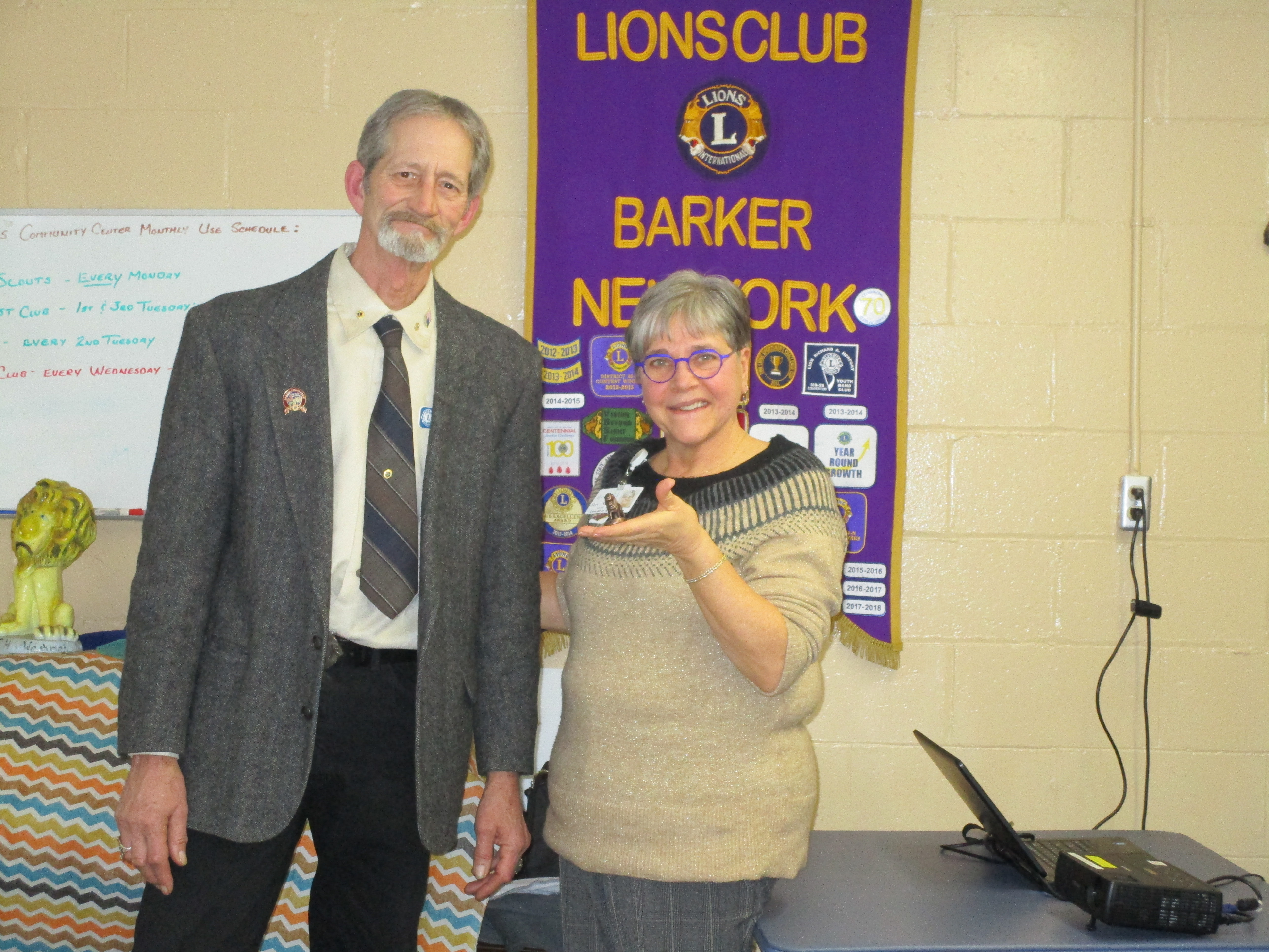 Lion President Tom Ware presents a Lion statue to Nancy Faery.