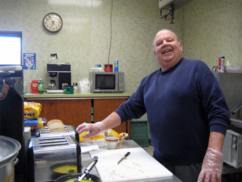 Lion Past President Frank Eldridge making toast at a recent pancake breakfast.